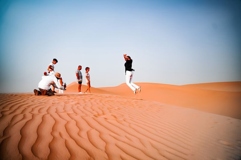 Abu Dhabi: Desert Safari with BBQ, Belly & Tanoura Dance - Sandboarding and a short camel ride slow the pace