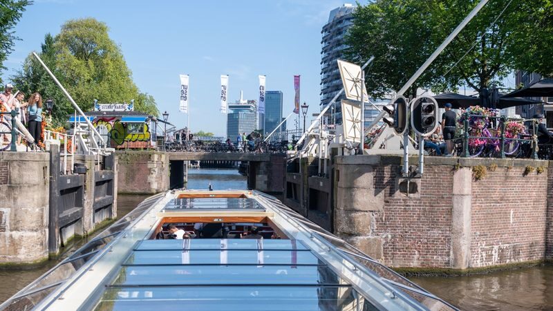 Amsterdam Evening Canal Cruise with Snackbox - Listening to the commentary