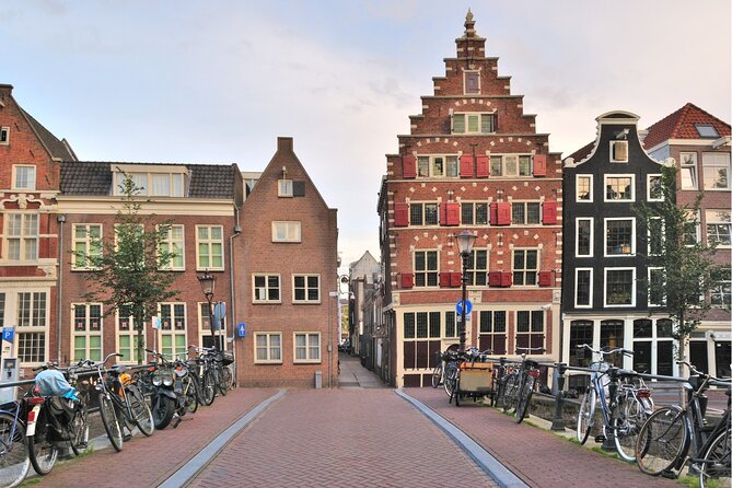 Amsterdam Highlights With Local: Walking Tour & Canal Cruise - Charming Canals and Bridges