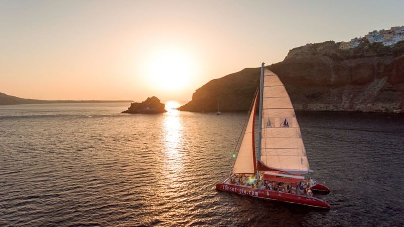 Catamaran red cruise experience with meal in Santorini - Santorini’s coast looks grander from the sea