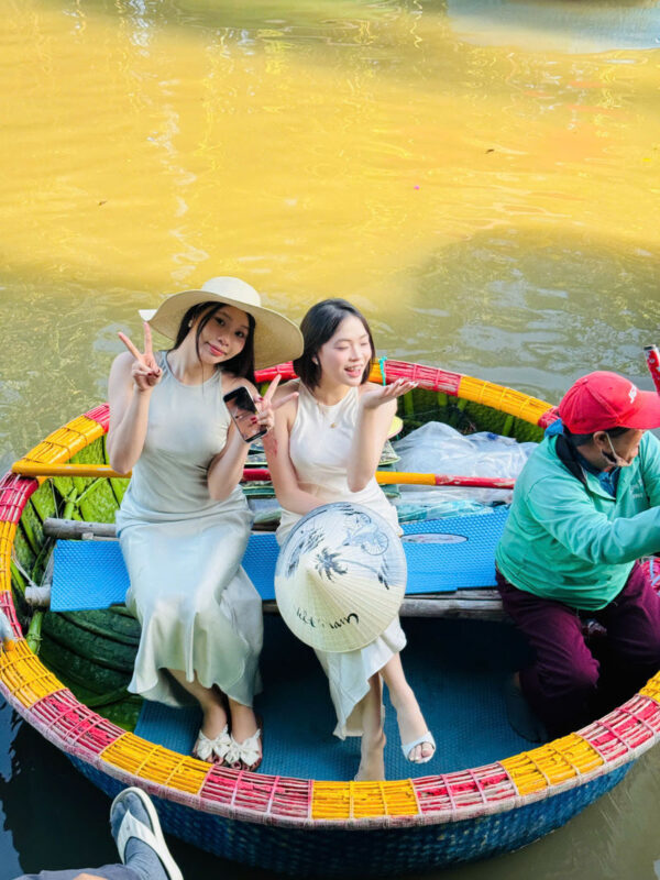 Coconut Village Basket Boat Ride & Hoi An Evening Tour With Dinner and Lantern Boat - Entering Hoi An as the lanterns come on