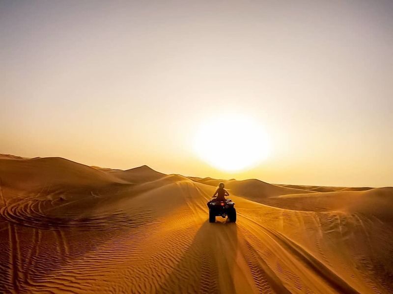 Deluxe Desert Safari Experience in Dubai - Sandboarding, camel ride, and photo stop