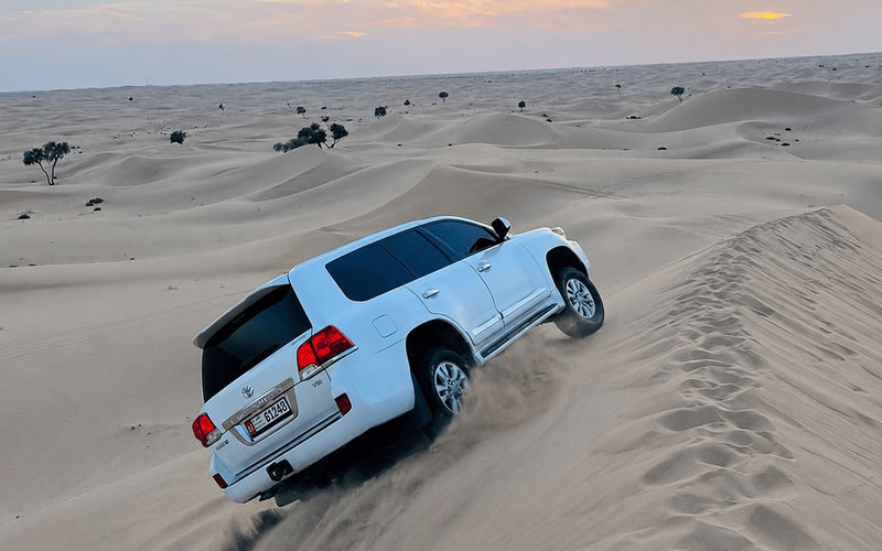 Doha Private Half-Day Desert Safari with Dune Bashing & Camel Ride - Sandboarding and the water at Khor Al Adaid