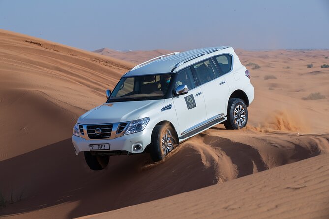 Dubai Desert Morning Dune Bashing, Sandboarding & Camel Ride - Sandboarding in the Red Dunes
