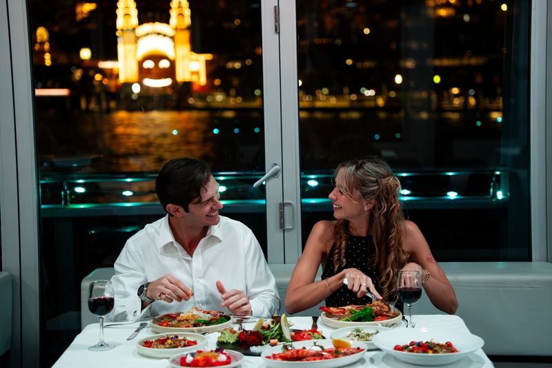 Glass Boat Dinner Cruise - A dinner table with a moving view