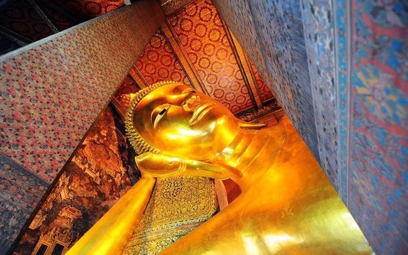 Half-day city tour of Bangkoks three major temples and the Grand Palace, departing in the morning by Panda Bus (A) - Wat Arun beside the Chao Phraya