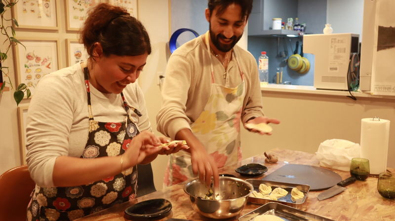 Handmade Gluten-Free Ramen and Gyoza Cooking Class in Osaka - Folding gyoza, then eating the results