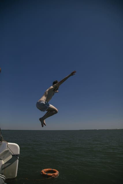 Lisbon: Catamaran Boat Party with Music, Open Bar & Dives - The Crew and Service
