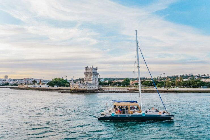 Lisbon: Sunset Catamaran- Music, a Drink & Christmas Lights - Highlights