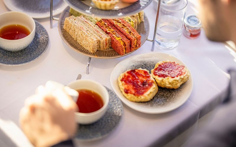 London Afternoon Tea Cruise on the River Thames - A tea table with a view of the Thames