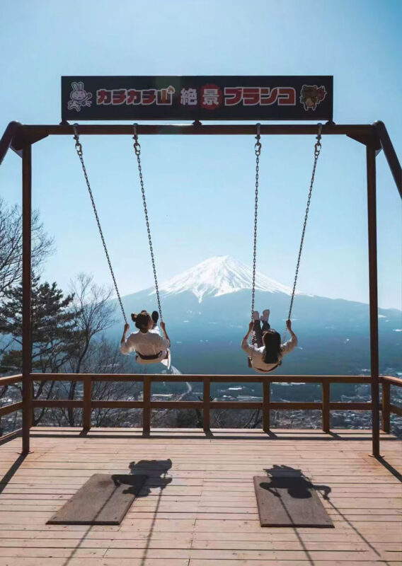 Mount Fuji and Lake Kawaguchi Panoramic Day Trip - Includes Mount Tenjo Park Ropeway Ticket (From Tokyo) - Hikawa Clock Shop frames Fuji down an old street