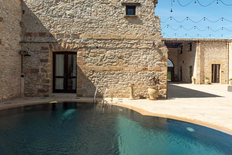 Nature and relaxation by the pool at Baglio Passofondo Estates - Authentic Touches and Experience Details