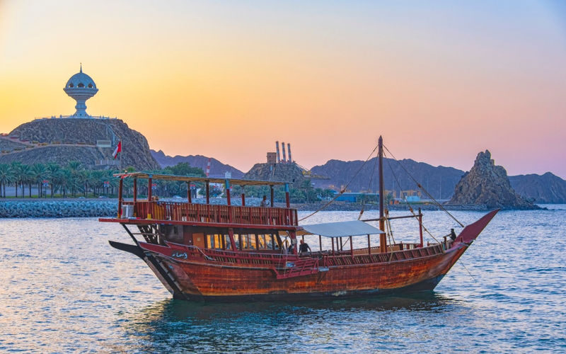 Omani Dhow sunset cruise experience in Muscat - A dhow brings the coast into view