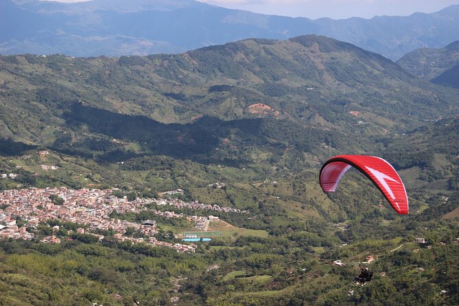 Paragliding Flight Over a Valley of Mountains and Waterfalls Video - Overview of Paragliding Flight Video