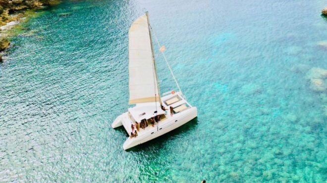 Porto Conte: Sunset Catamaran Excursion With Aperitif - Duration and Languages