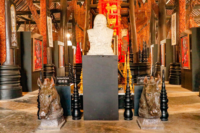 Private Black House, White Temple and Blue Temple Trip by TTD Global - Baan Dam Museum: dark buildings, bone, and fur