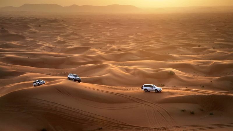 Red Dunes Desert Half-Day Safari with Live Entertainment - Red sand, open sky, and a fast 4x4 ride