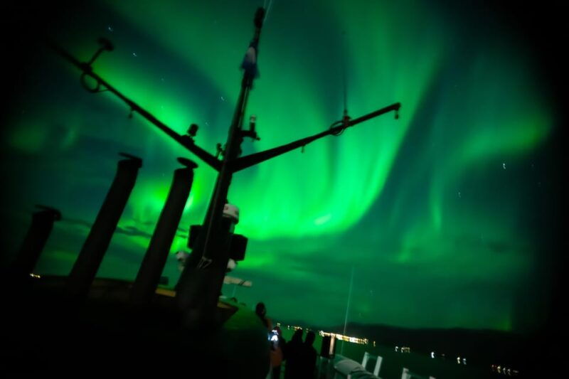 Reykjavik: Northern Lights Guided Boat Tour with Photos - Aurora Hunting and the Scenic Backdrop  