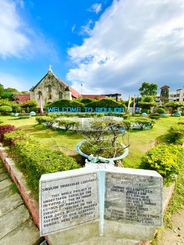 Siquijor Tourist Spots and Top Attractions (Admission Fees Included) - Welcome marker and St. Francis of Assisi Church